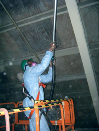 manually cleaning overhead dust