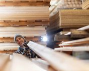 Happy employee in wood production facility