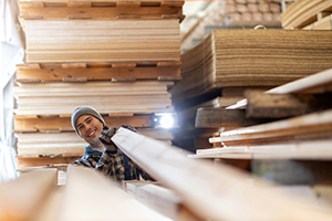 Happy employee in wood production facility