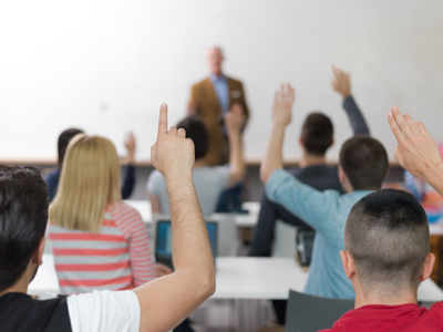 students group raise hands up on class